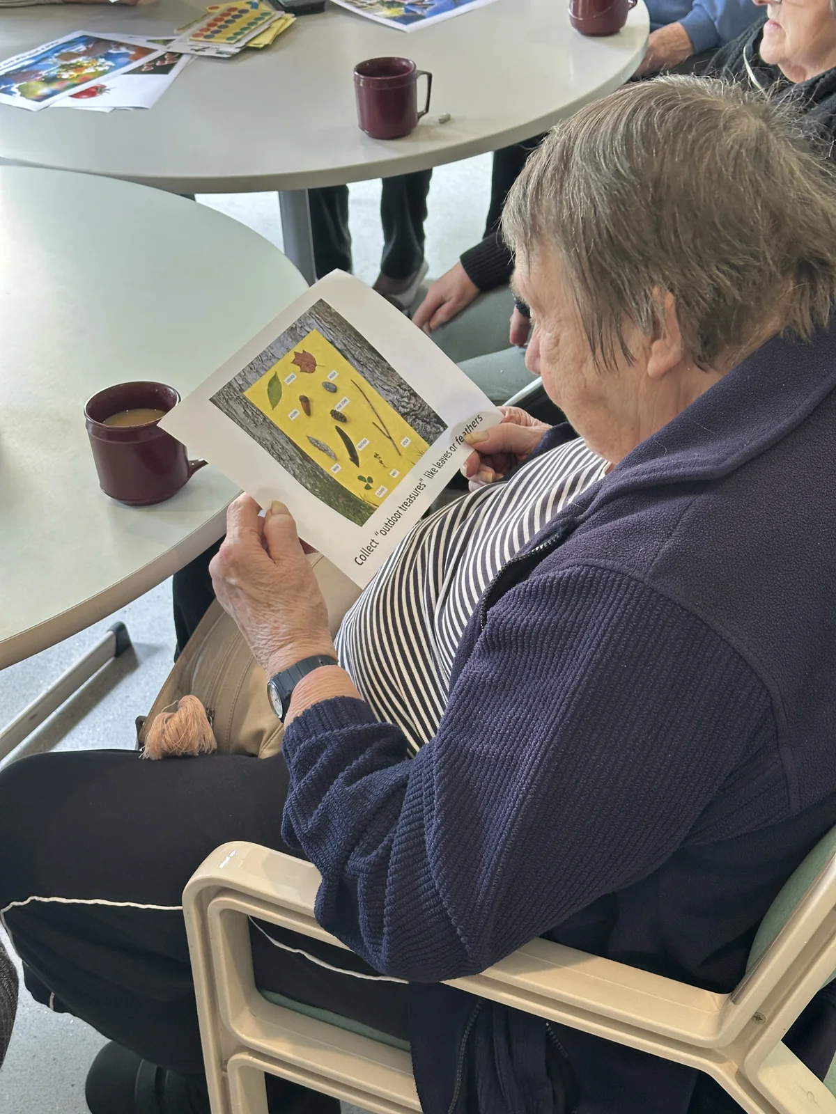 A resident looking through an illustrated activity booklet