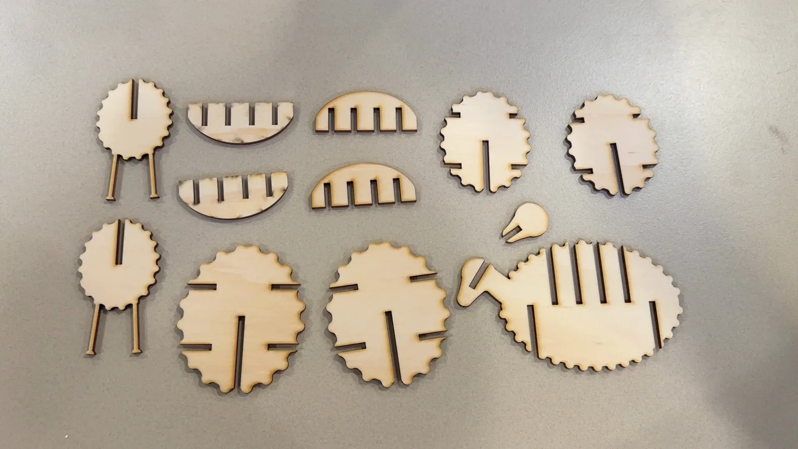 An early wooden sheep model laid out as separate interlocking parts